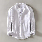 White collarless linen shirt flat lay, front view highlighting button placket and clean lines