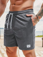 Front detail of beige corduroy shorts showing drawstring tie and ribbed texture