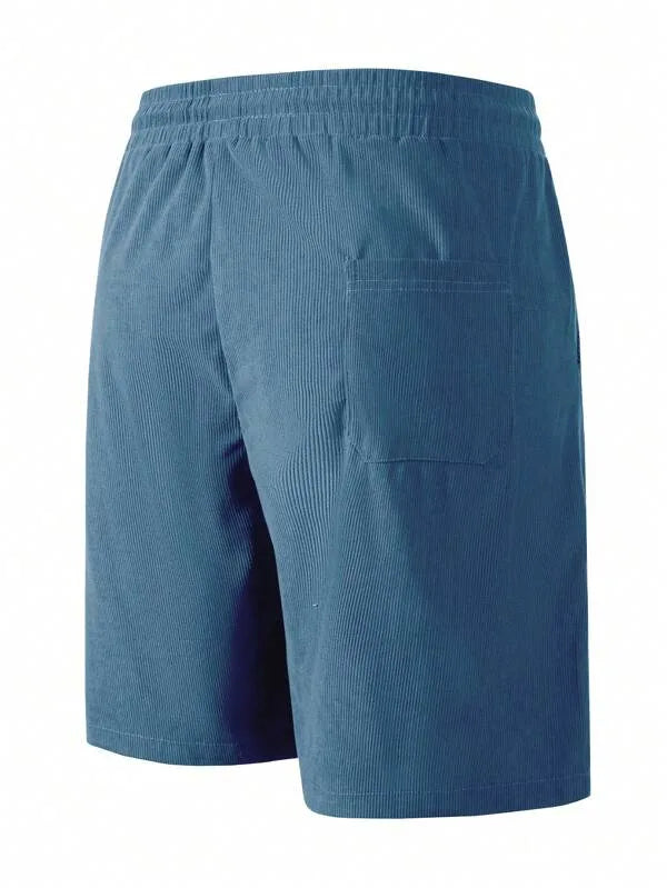 Back view of teal blue corduroy shorts showing elastic waistband and patch pocket