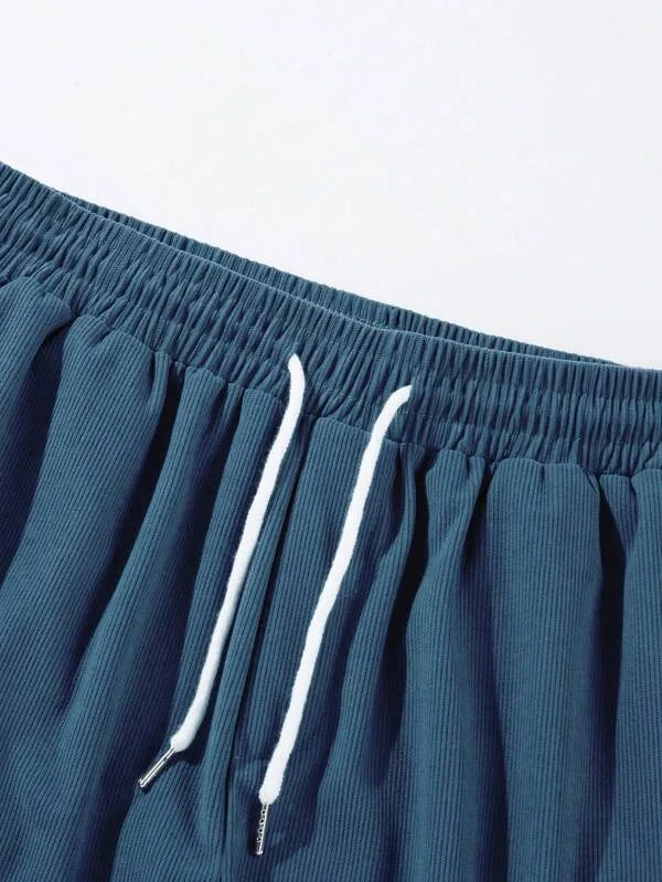 Close-up of ribbed corduroy waistband with white drawstring cord and metal tips
