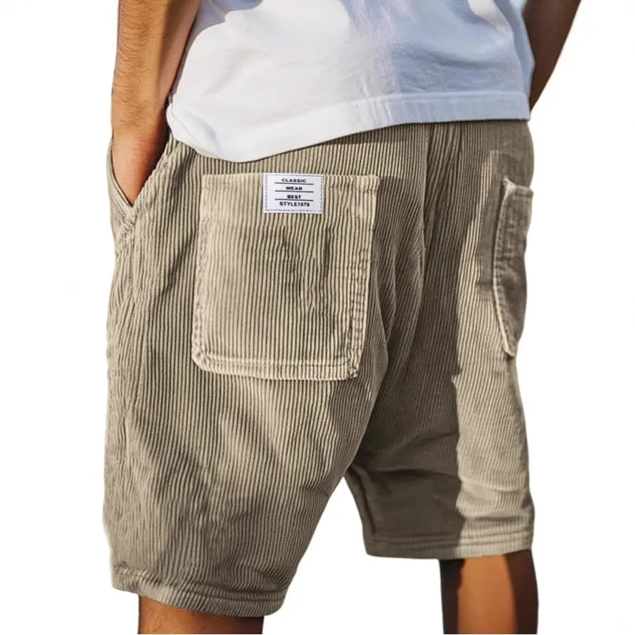 Khaki corduroy shorts shown from behind, highlighting the ribbed texture and woven brand patch