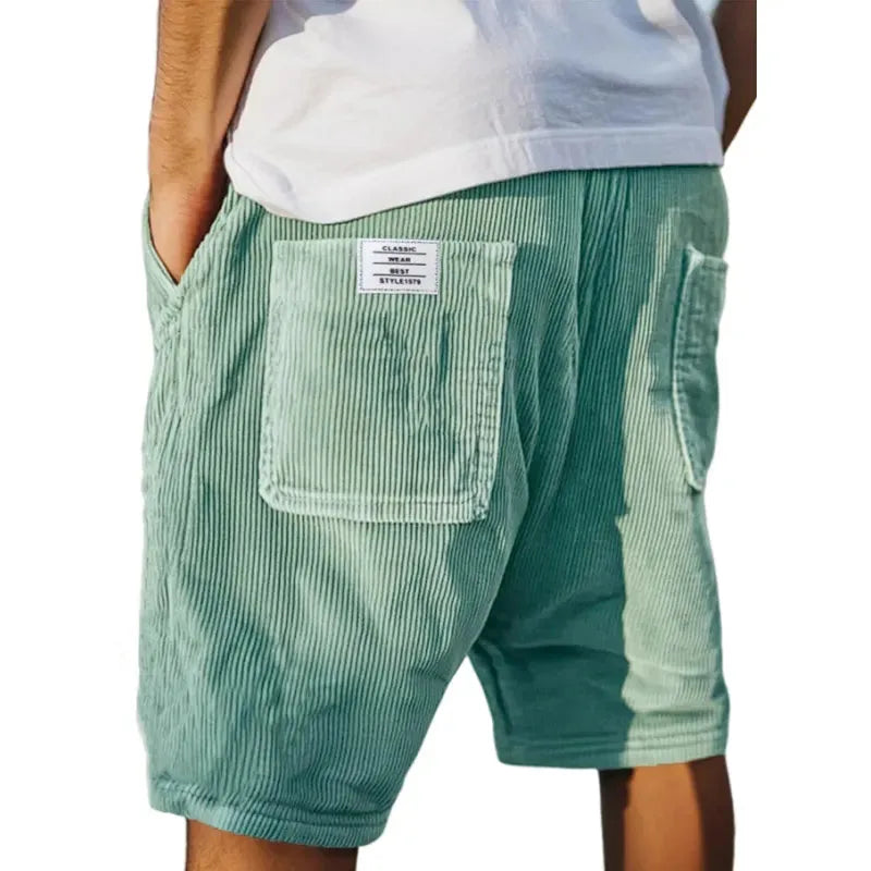 Sage green corduroy shorts, rear view showing the deep ribbed fabric and relaxed fit