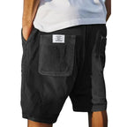 Black corduroy shorts from the back, showing the patch pocket detail and relaxed knee-length cut
