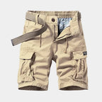 Beige cargo shorts laid flat, front view, showing webbing belt, zip fly and flap cargo pockets