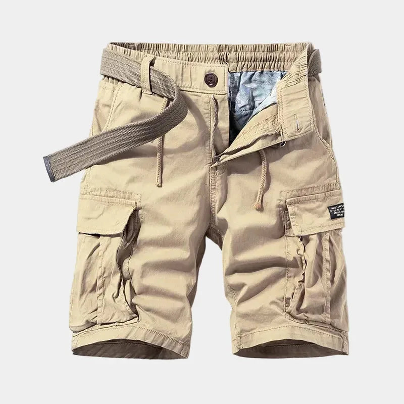 Beige cargo shorts laid flat, front view, showing webbing belt, zip fly and flap cargo pockets