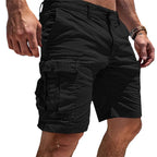 Black cotton cargo shorts photographed from the side, showing the structured waistband and large side pocket