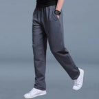 Close-up side view of charcoal grey jogger pants with clean seam detailing and relaxed straight leg.