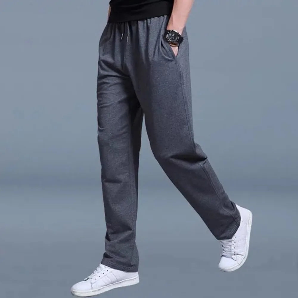 Close-up side view of charcoal grey jogger pants with clean seam detailing and relaxed straight leg.