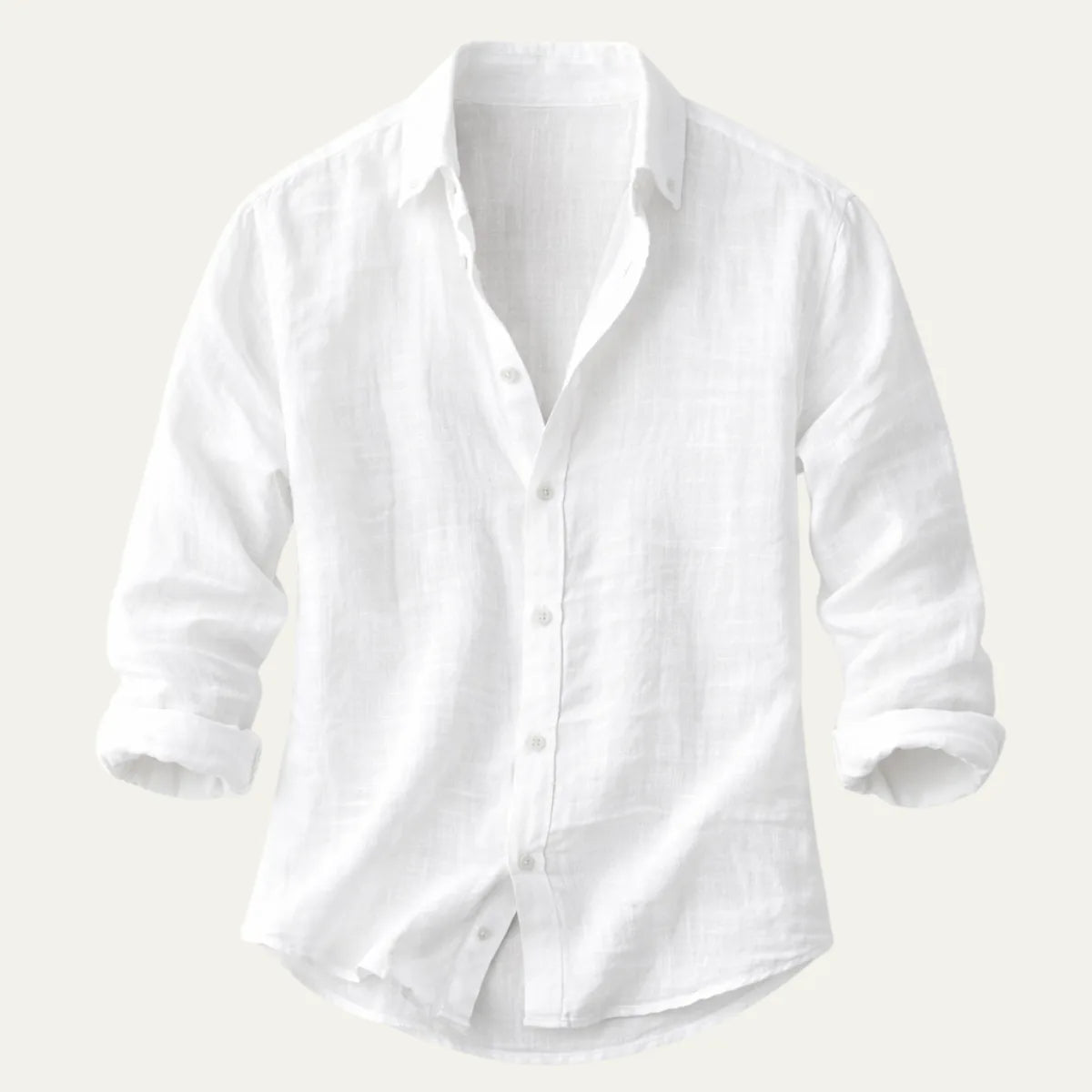 Flat lay of a white cotton-linen button-up shirt with rolled sleeves on a plain background