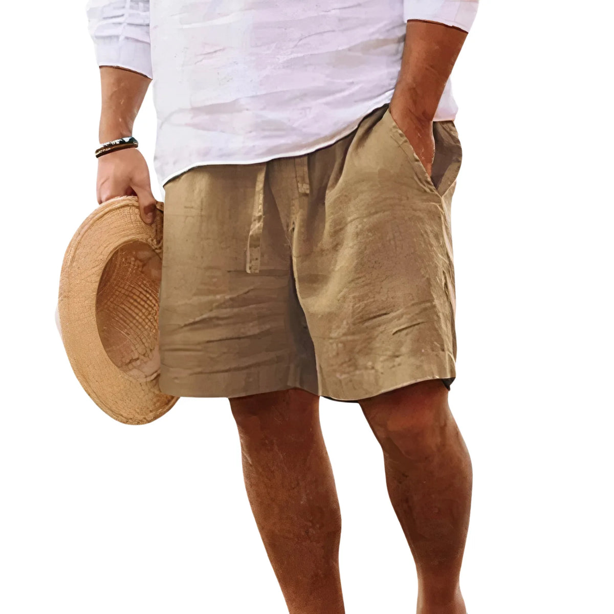 Front view of a man in a white linen shirt holding a straw hat, shorts paired as part of a summer outfit