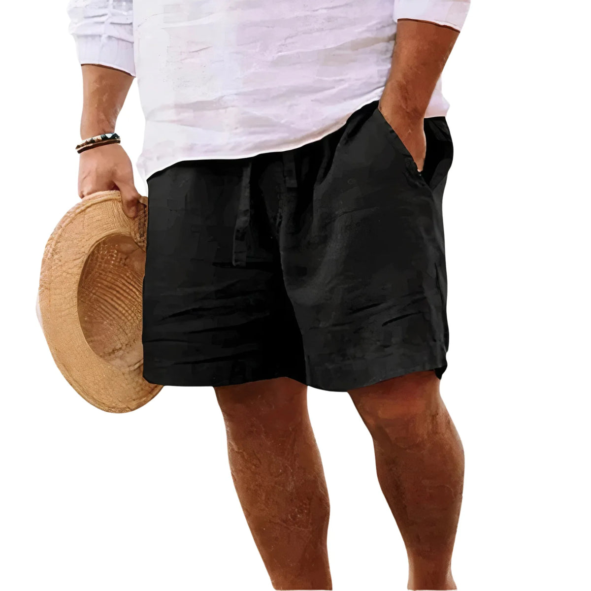 Side view of a man wearing black drawstring shorts with hand in pocket, cropped below the waist
