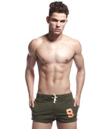 Close-up front view of army green sport shorts with drawstring waist and orange number 9 print