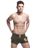 Back view of army green sport shorts showing fitted waistband and single zip-trim pocket