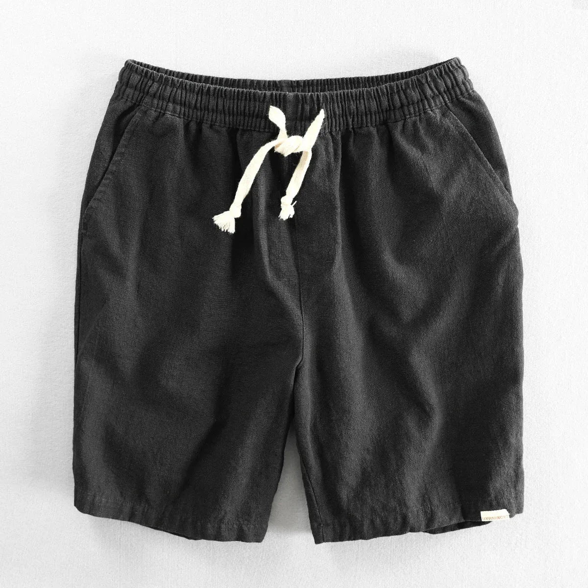 Black drawstring shorts flat lay highlighting the relaxed fit and natural fabric texture