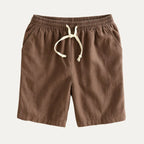 Brown drawstring shorts flat lay showing clean silhouette and side seam pockets
