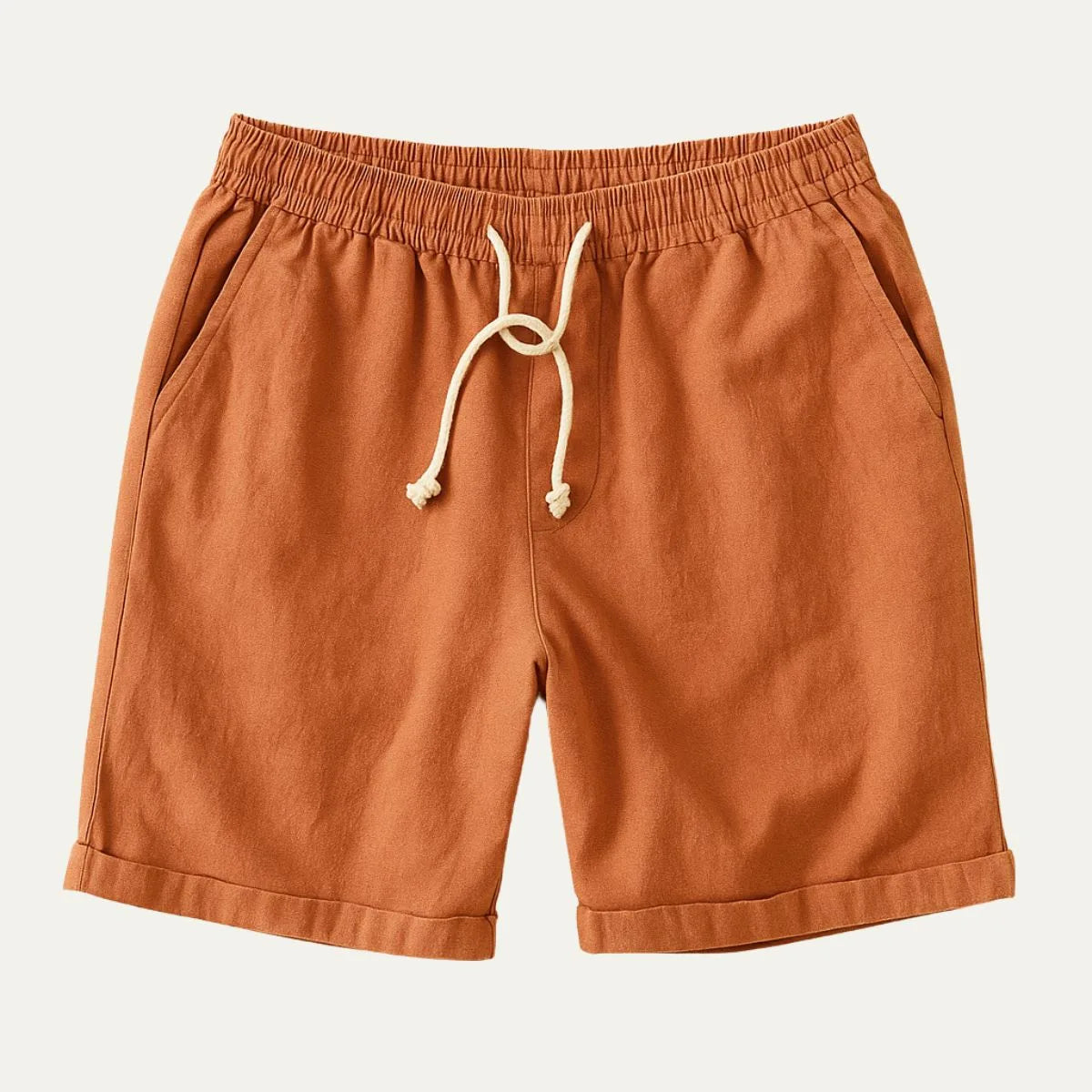 Rust orange shorts flat lay with rolled hem detail and drawstring waist closure