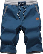 Front view of knee-length drawstring shorts in steel blue with grey ribbed waistband and striped pocket trim