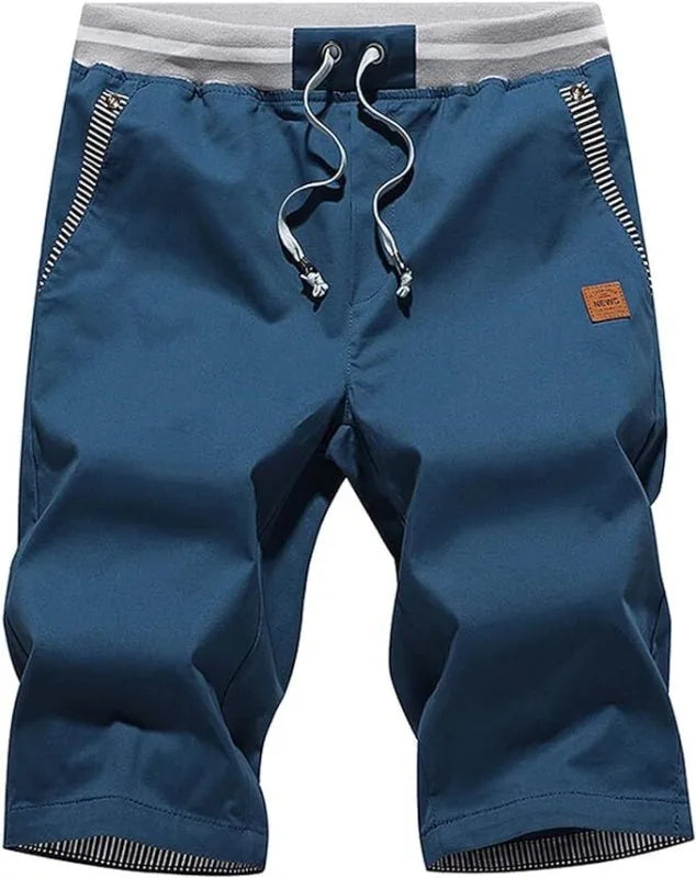 Front view of knee-length drawstring shorts in steel blue with grey ribbed waistband and striped pocket trim