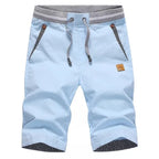 Flat lay of knee-length drawstring shorts in pale sky blue with striped pocket trim
