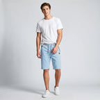 Model wearing sky blue drawstring shorts paired with a white t-shirt and sneakers, front view