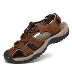 Angled view of a brown leather fisherman sandal with toe guard, bungee lace lock and adjustable hook-and-loop ankle strap