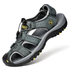Side angle of a grey leather closed-toe sandal showing the chunky lugged outsole and mesh side vents
