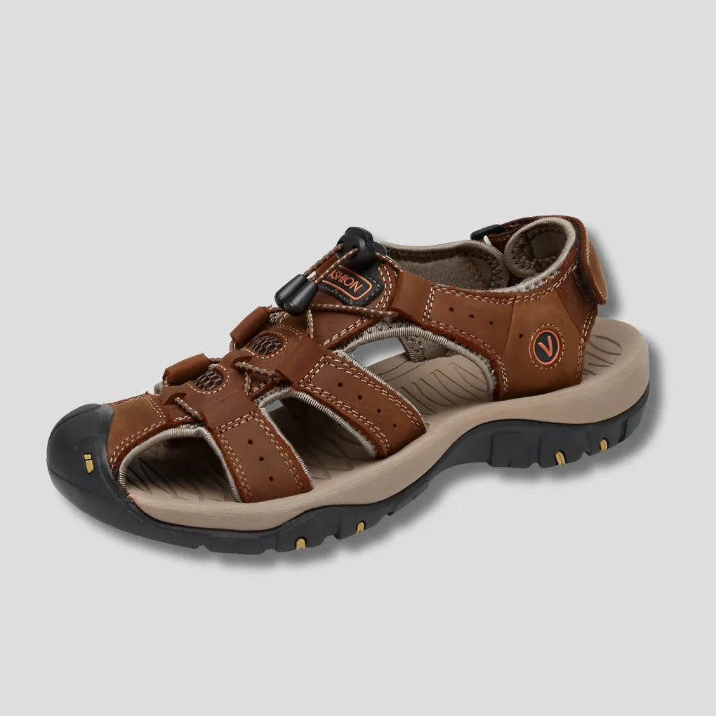 Brown leather sandal on plain background showing the full profile, rounded toe cap and layered straps