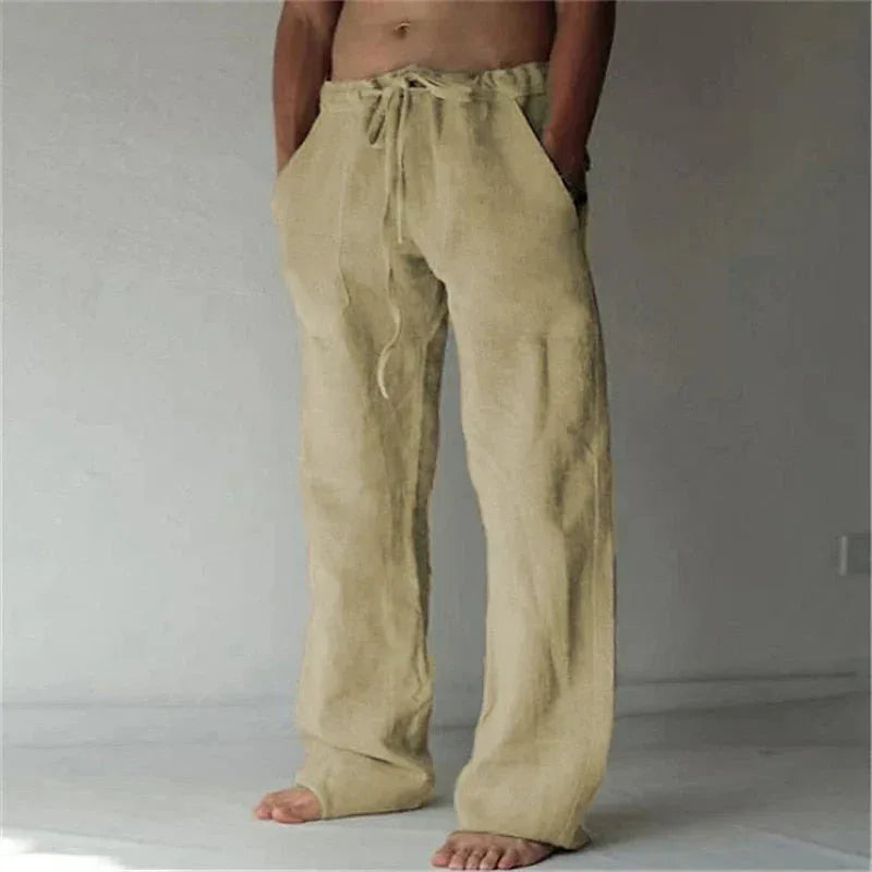 Khaki beige linen drawstring pants with a loose straight-leg cut, styled with no footwear
