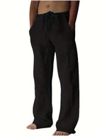 Black linen-style drawstring pants with a relaxed fit, close-up front view showing waistband tie