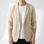 Man wearing the beige linen blazer open over a white t-shirt and black pants, front view close-up