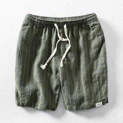 Flat lay of green pinstripe linen-blend shorts with elastic drawstring waist on a grey background