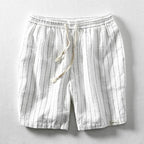 White pinstripe cotton-linen shorts laid flat, showing drawstring waist and side seam detail