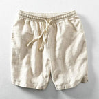 Plain khaki linen-blend shorts flat lay, showing textured weave and elastic drawstring waist