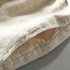 Close-up of the woven linen-blend fabric texture and stitched hem detail