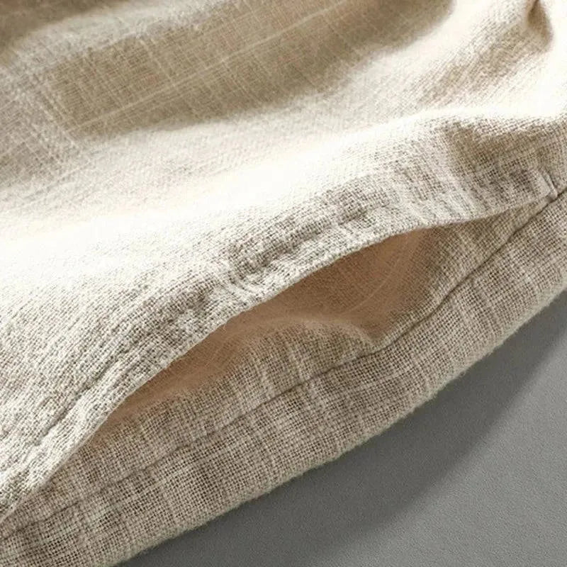 Close-up of the woven linen-blend fabric texture and stitched hem detail