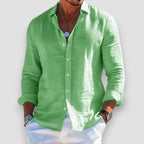 Light green linen-blend shirt with relaxed collar and button front, sleeves rolled above the wrist