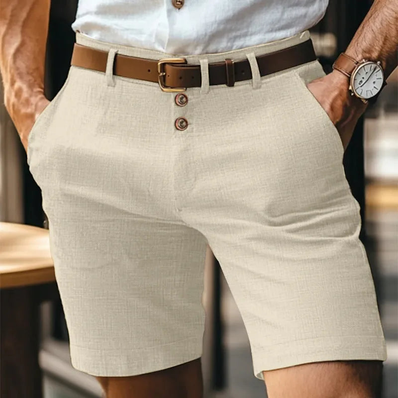 Beige linen-blend shorts with double-button fly closure and textured woven fabric, worn with a brown belt