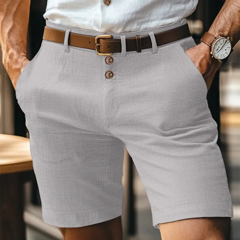 Light grey linen shorts front view showing tailored straight-leg cut and brown leather belt detail