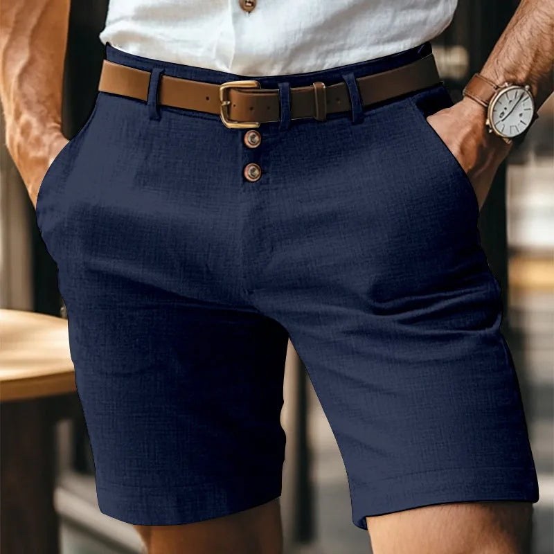 Navy blue linen shorts shown front-on with brown leather belt and classic button-fly closure