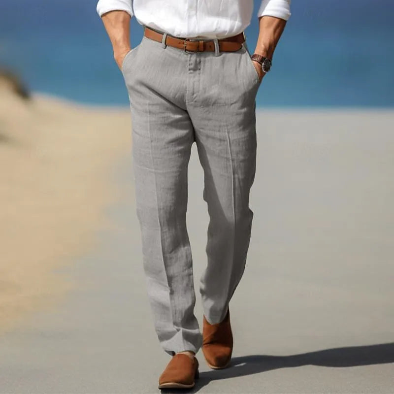 Close-up rear view of man walking in light grey linen trousers with a leather belt
