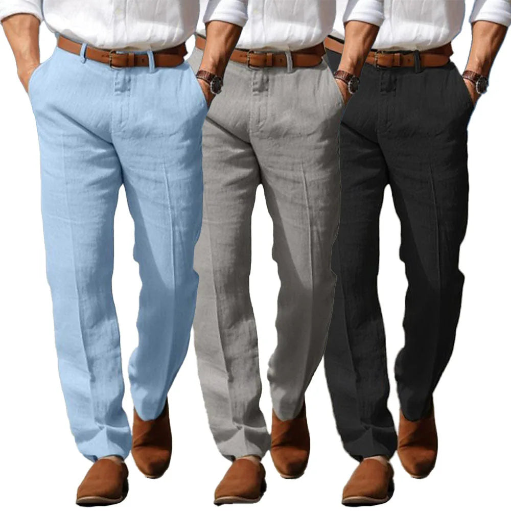 Three men side by side modelling the trousers in light blue, grey and black colourways