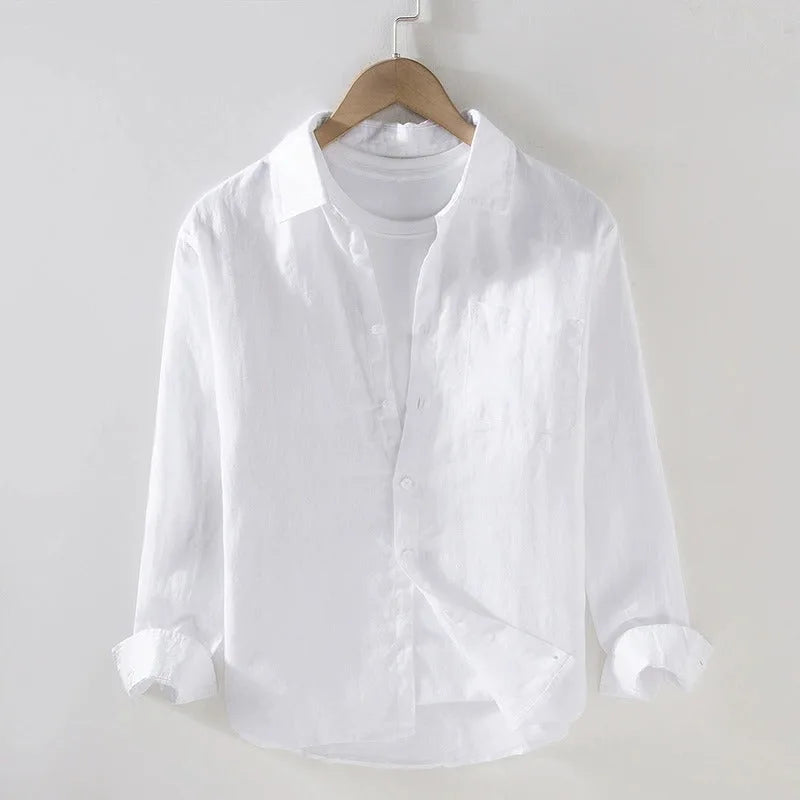 White linen shirt on a hanger, front view highlighting the lightweight fabric and rolled cuff detail
