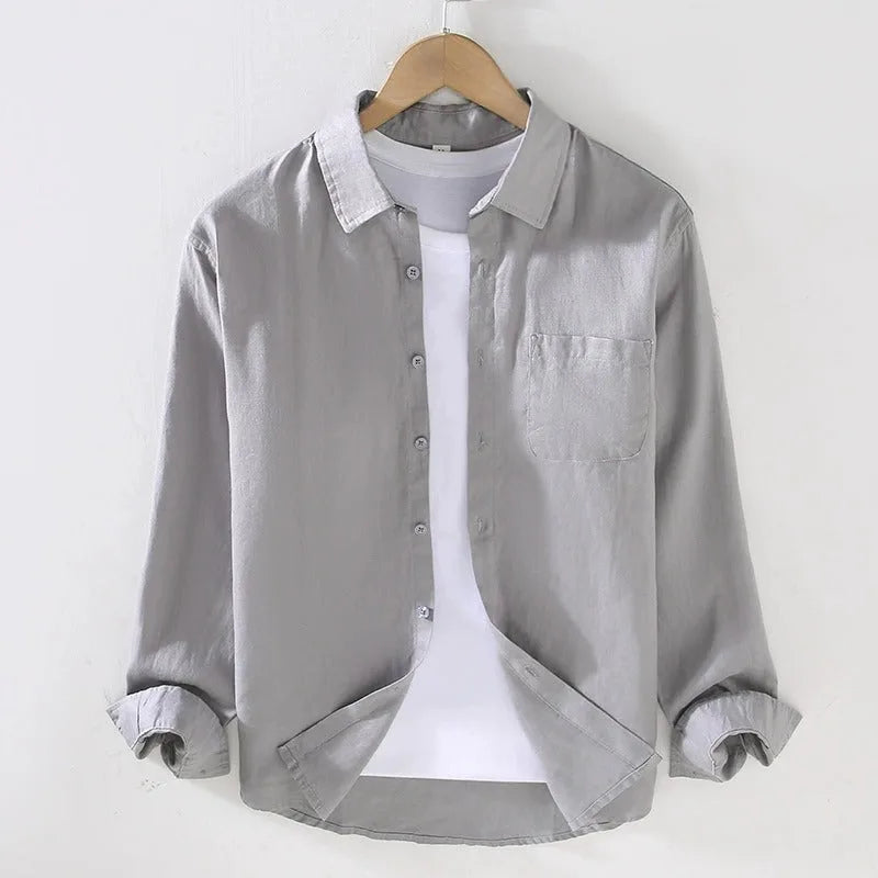 Grey linen shirt on a hanger, front view with rolled sleeves and visible linen texture