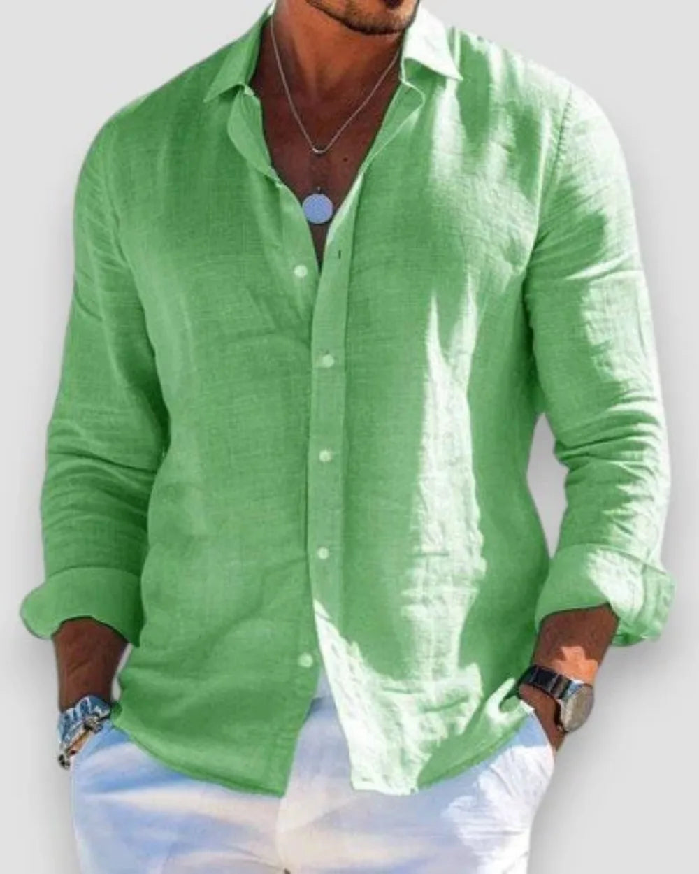 Model with hands in pockets wearing an open-collar linen shirt, showing the relaxed drape and fit