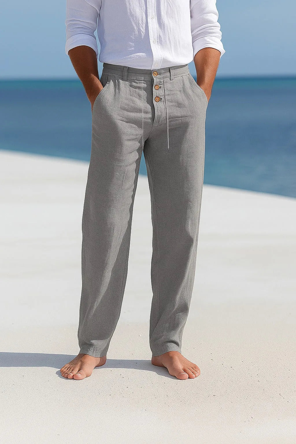 Grey linen trousers shown from the front, highlighting the loose straight cut and natural fabric texture