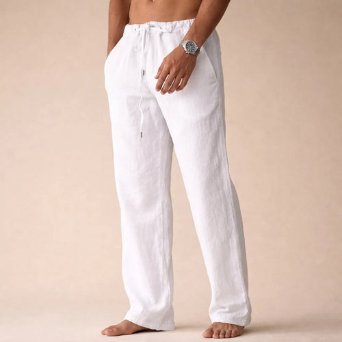 Front view of man wearing white linen drawstring pants with relaxed straight leg and side pockets