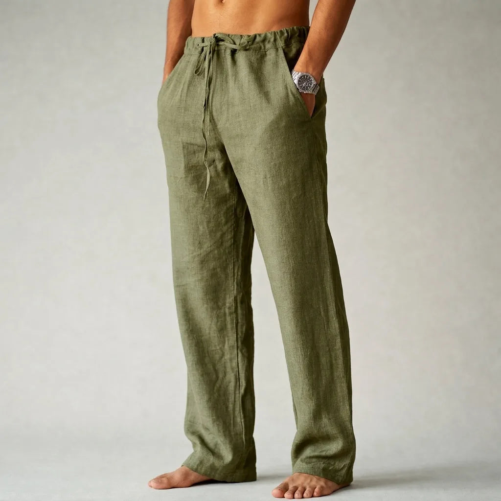 Side view of olive green linen drawstring trousers showing relaxed fit and raw-hem ankle length