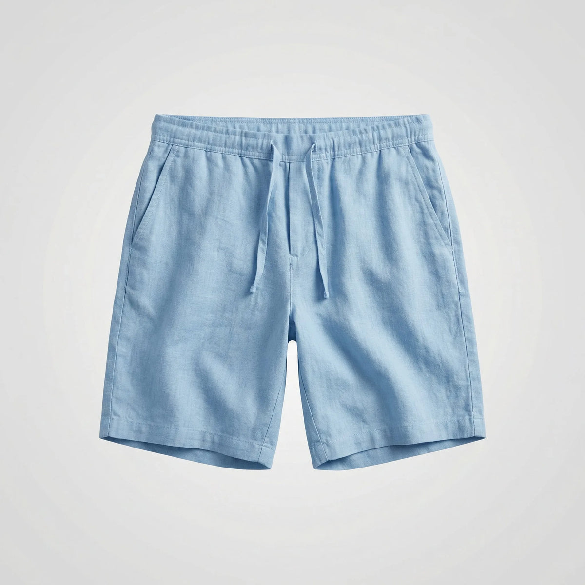Light blue linen shorts shown flat, featuring an elasticated drawstring waist and side pockets