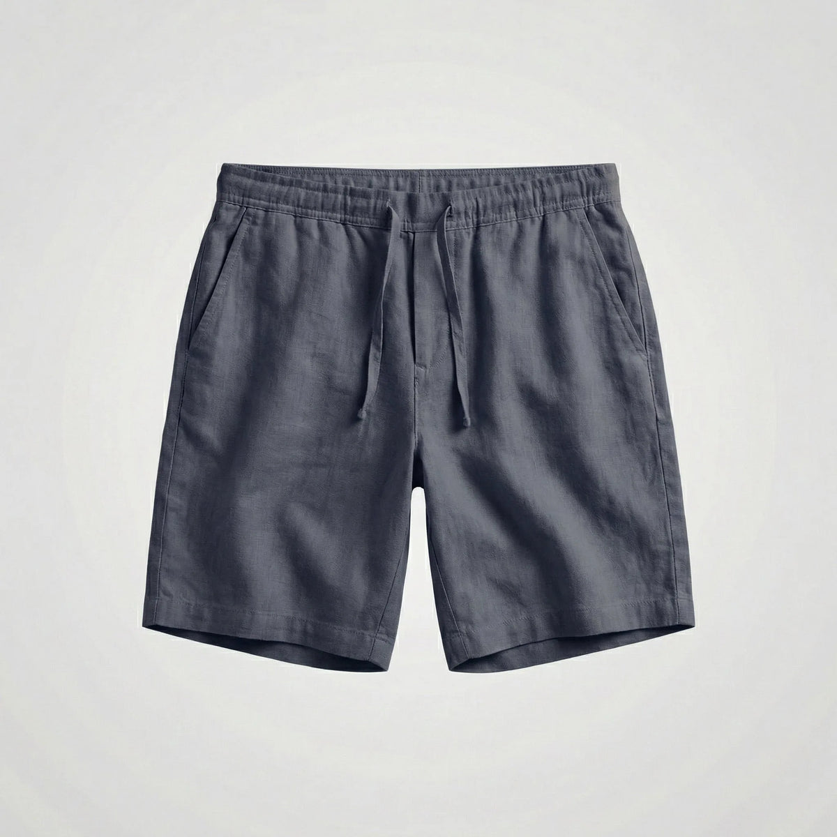 Close-up of the stitched pocket opening on black linen shorts