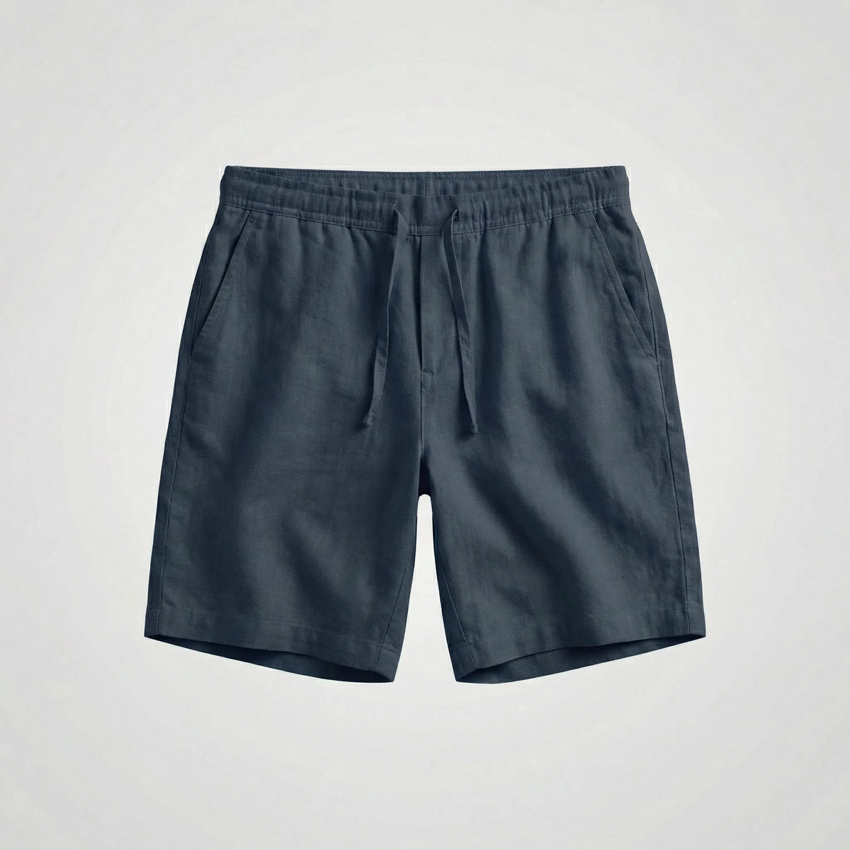 Close-up of the woven linen fabric texture on green shorts